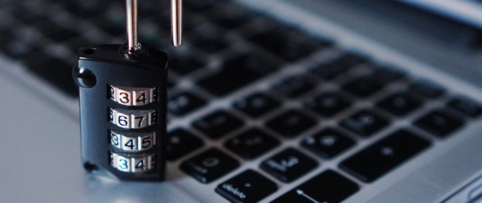 A combination lock resting on a laptop keyboard